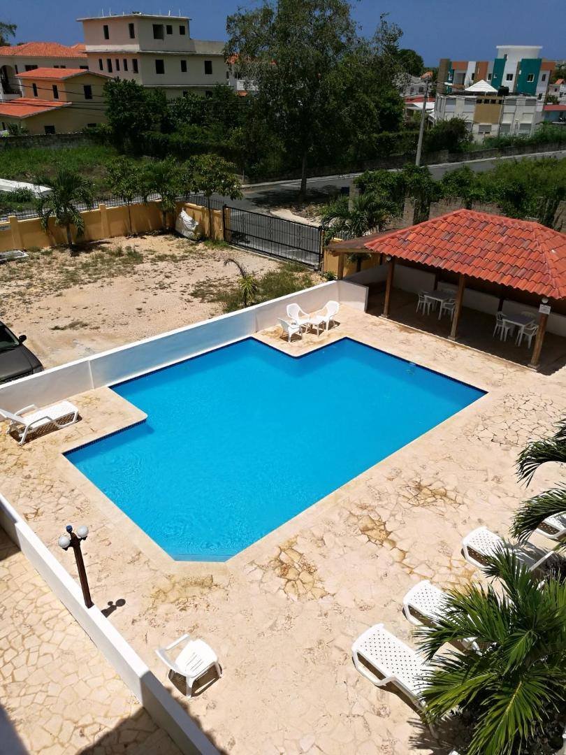 Aerial-style view of the pool and the gazebo next to the apartment buildings
